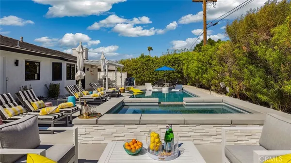 a view of a swimming pool with a lounge chairs