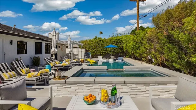 a living room with furniture and a floor to ceiling window