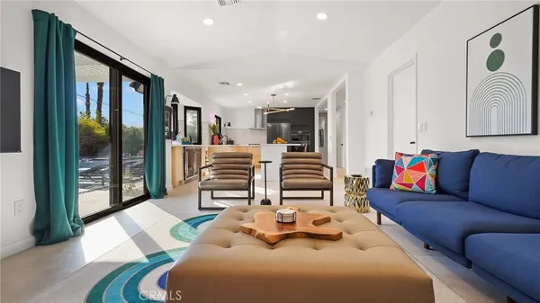 a living room with furniture and a floor to ceiling window