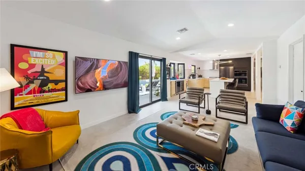 a living room with furniture and wall paintings