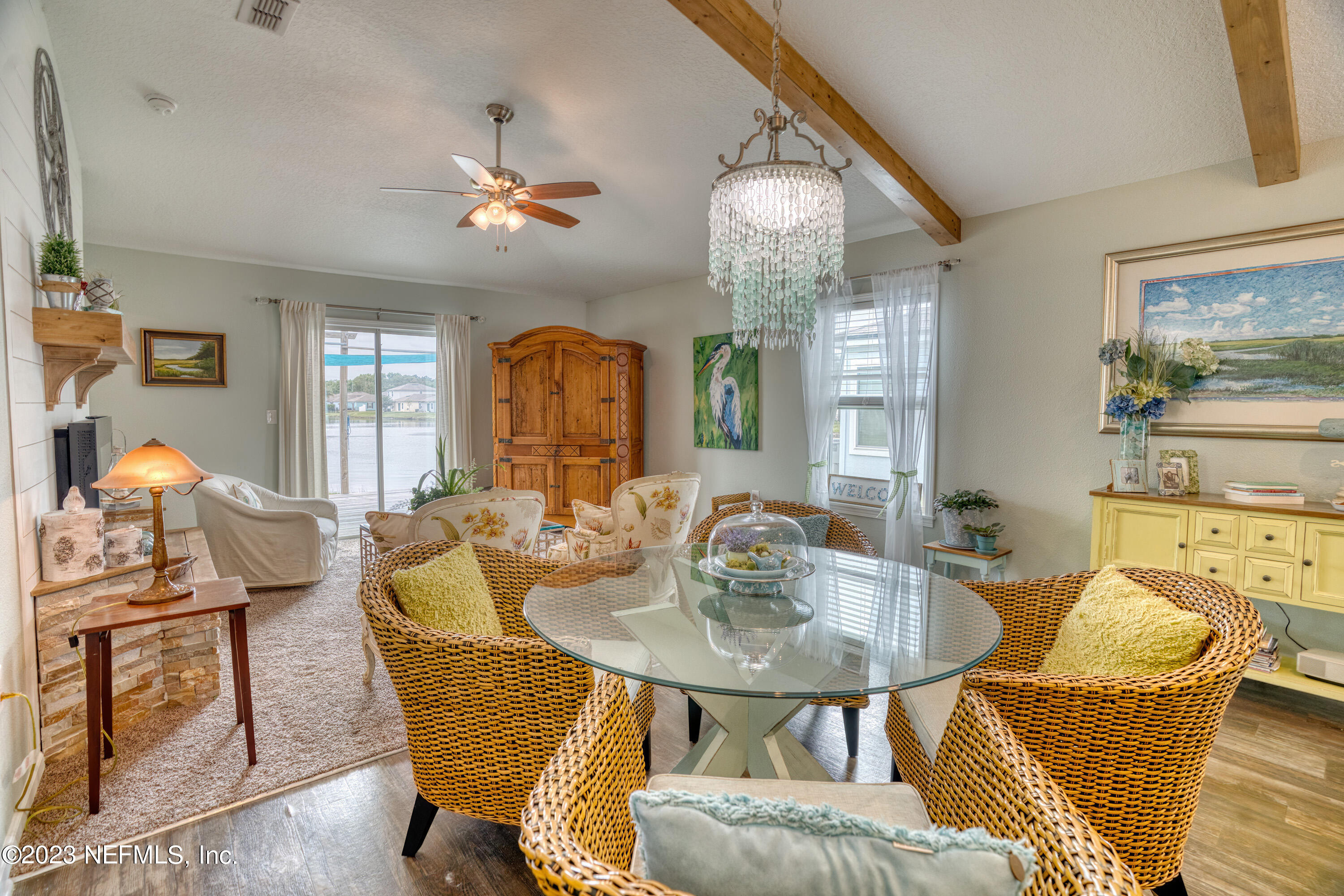 583 Ashby Landing Way St. Augustine, FL 32086 - Photo 11 of 48 a dining room with furniture a chandelier and wooden floor