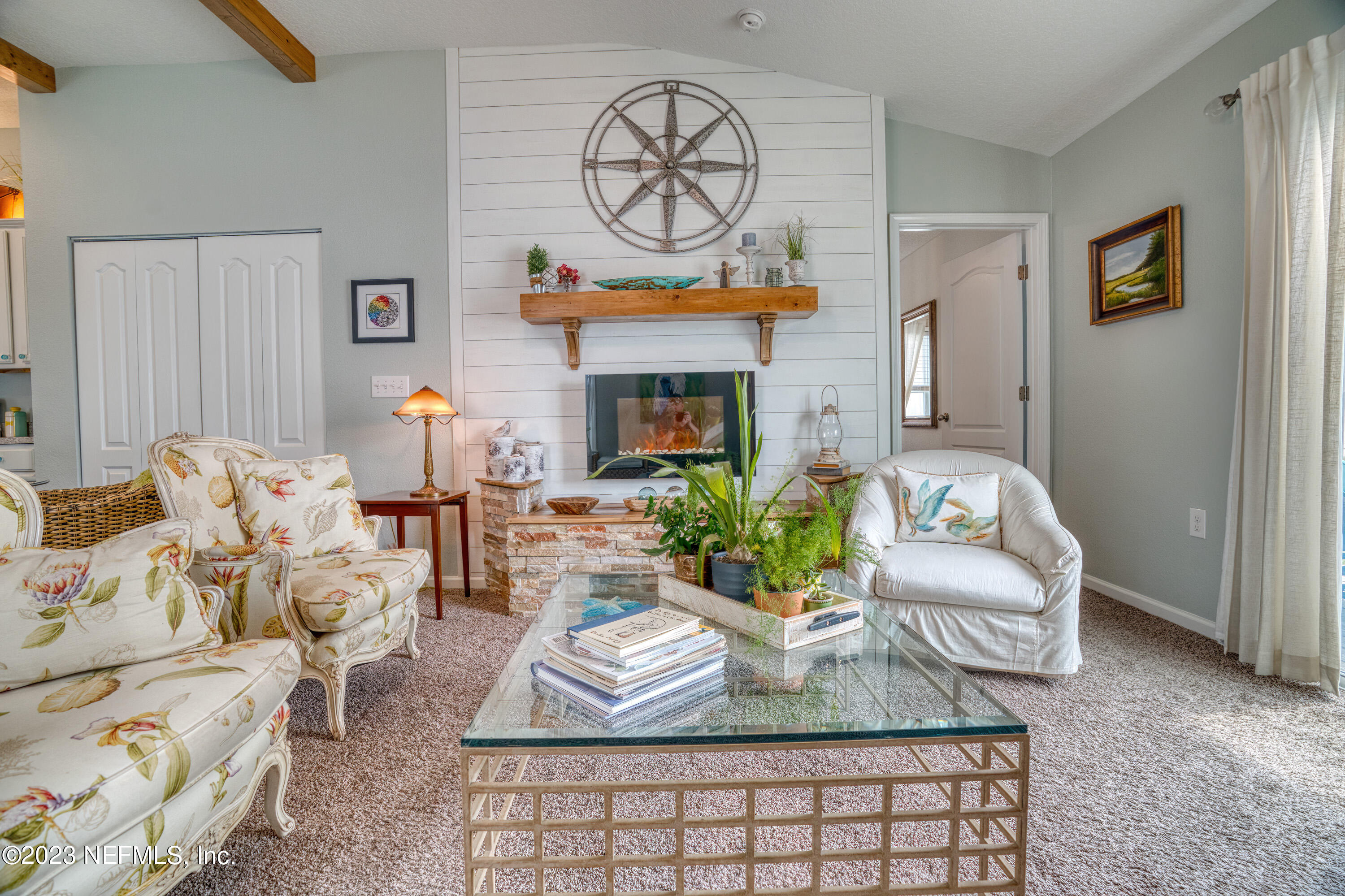 583 Ashby Landing Way St. Augustine, FL 32086 - Photo 18 of 48 a living room with furniture a fireplace and a potted plant