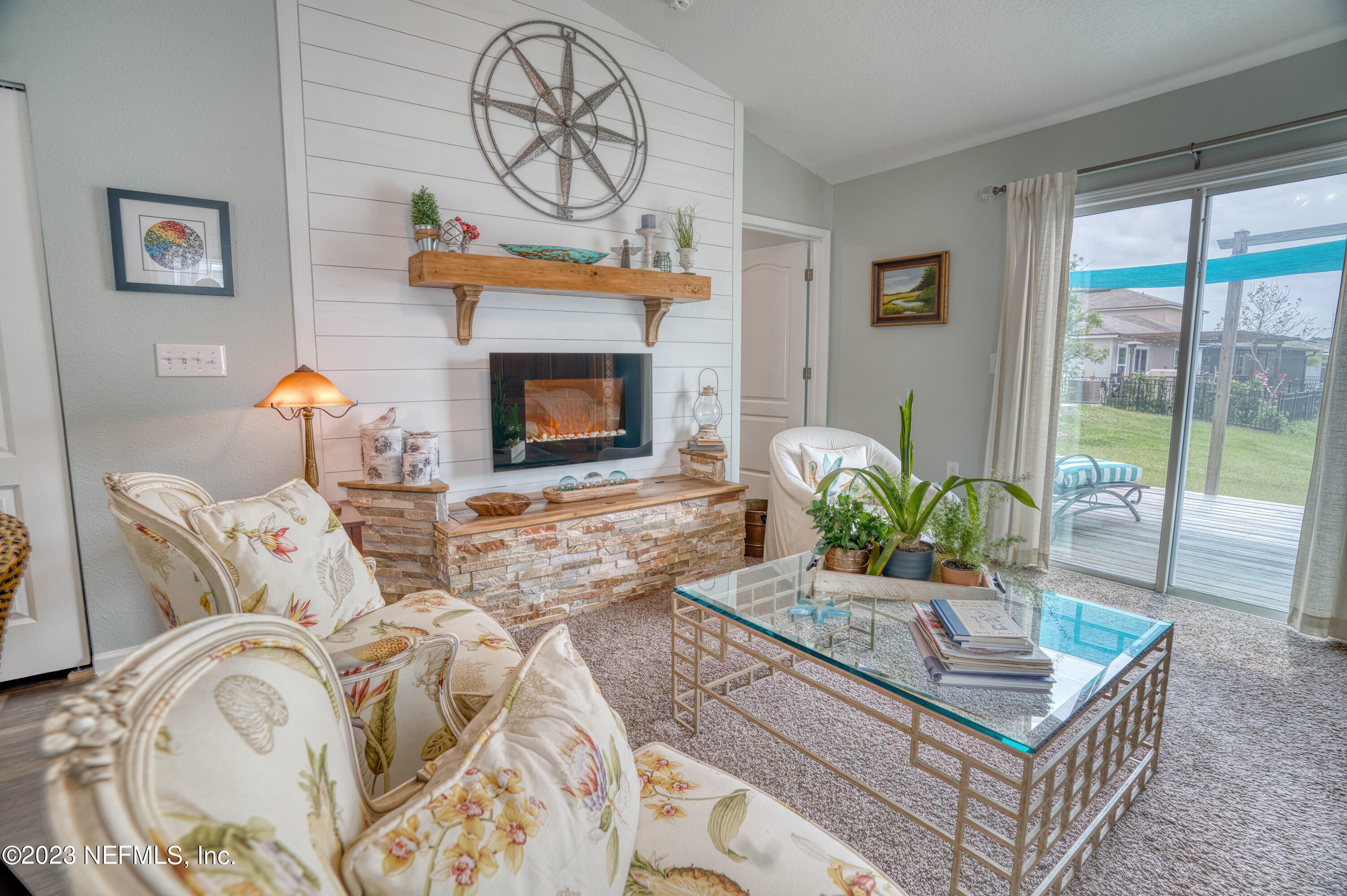 583 Ashby Landing Way St. Augustine, FL 32086 - Photo 19 of 48 a living room with furniture a flat screen tv and a fireplace