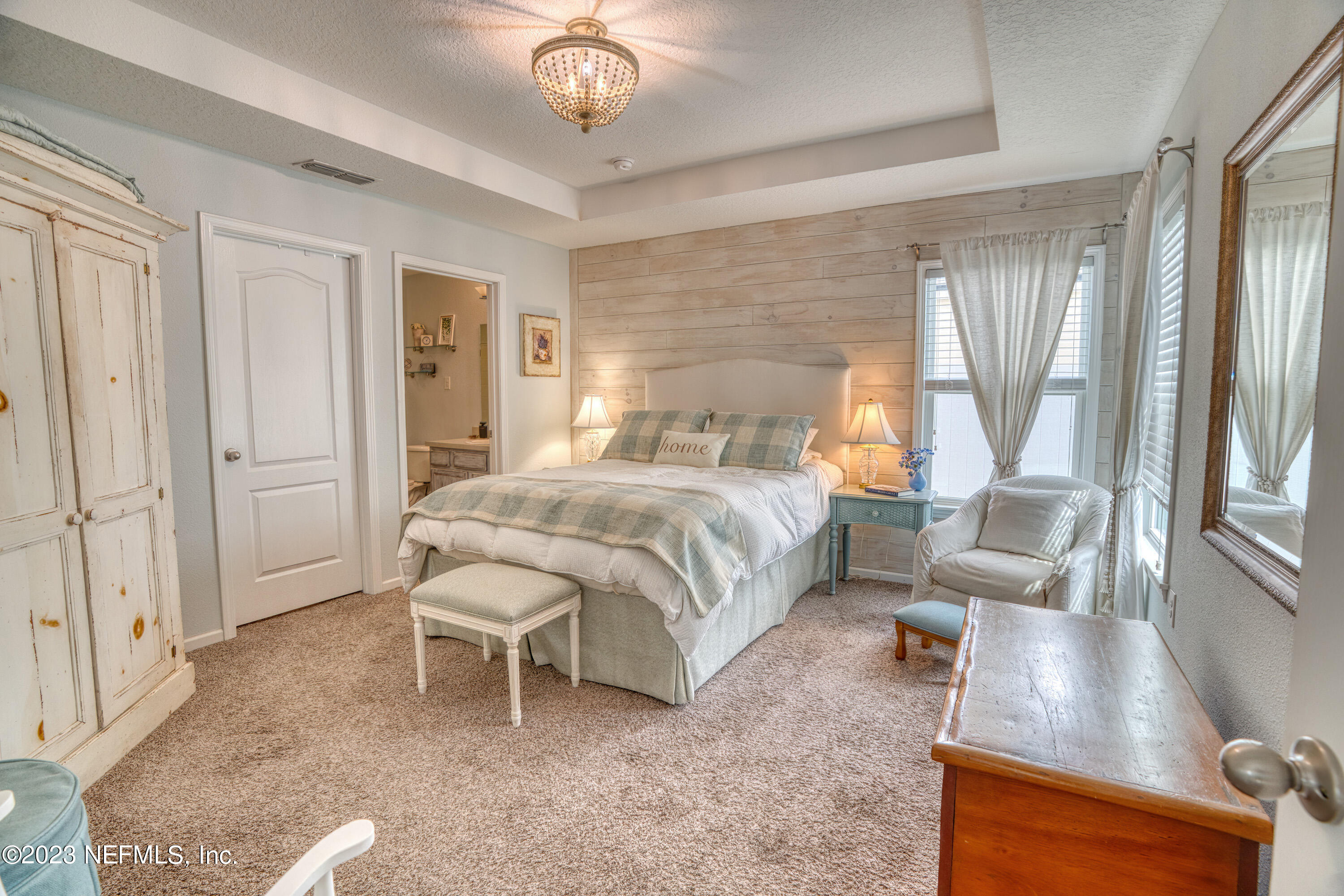 583 Ashby Landing Way St. Augustine, FL 32086 - Photo 20 of 48 a bedroom with a large bed and a large window