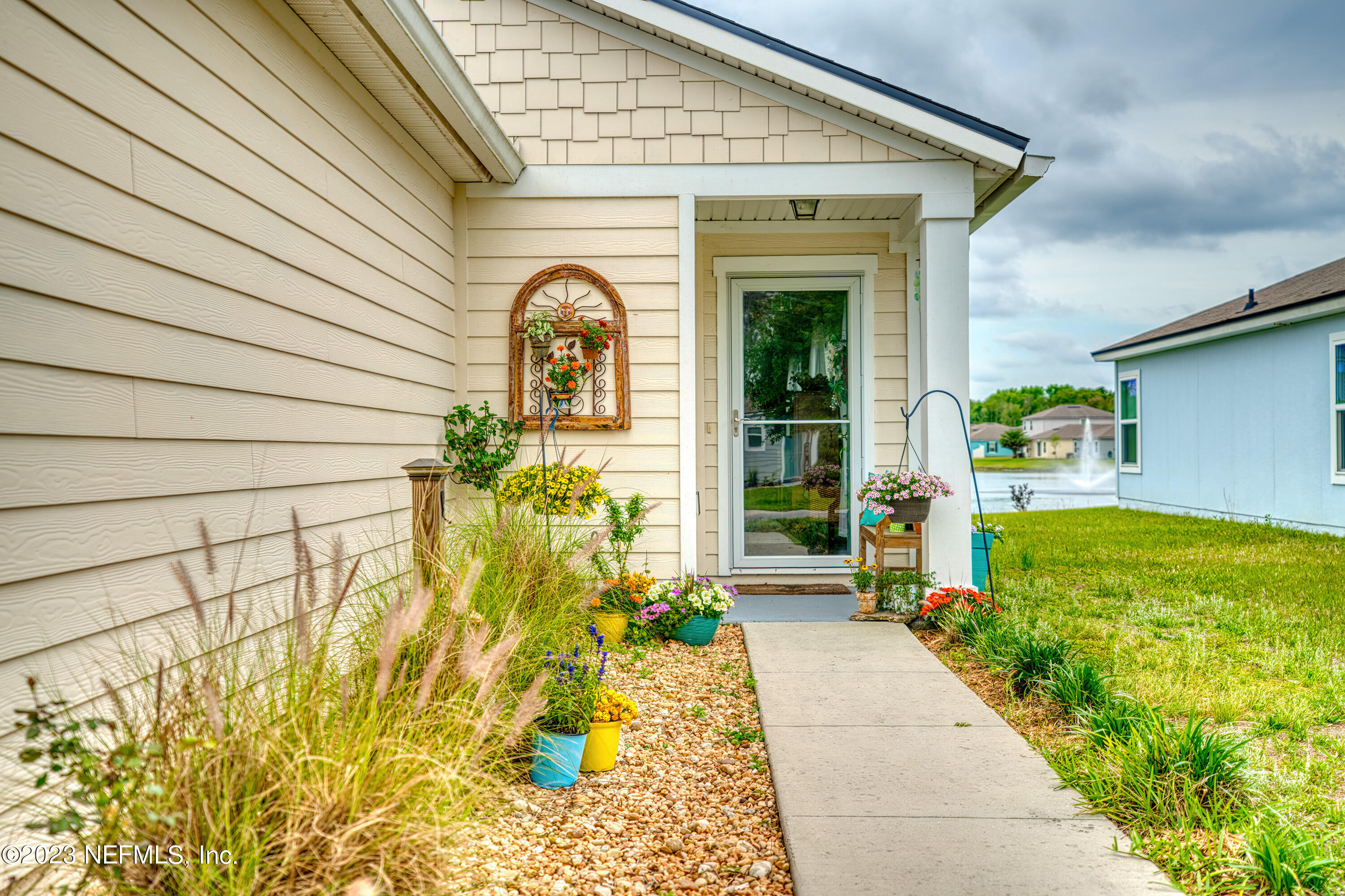 583 Ashby Landing Way St. Augustine, FL 32086 - Photo 3 of 48 a front view of a house with a garden