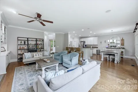 a living room with furniture kitchen and a table