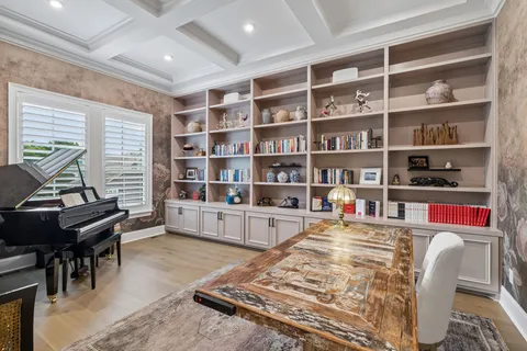 a dining room with furniture a fireplace and wooden floor
