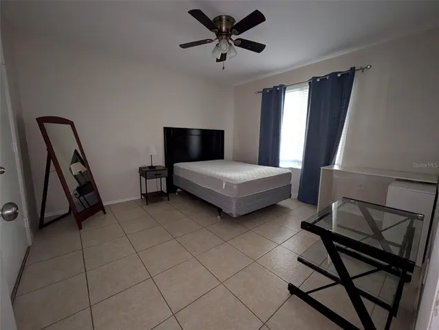 a bedroom with double bed and a window