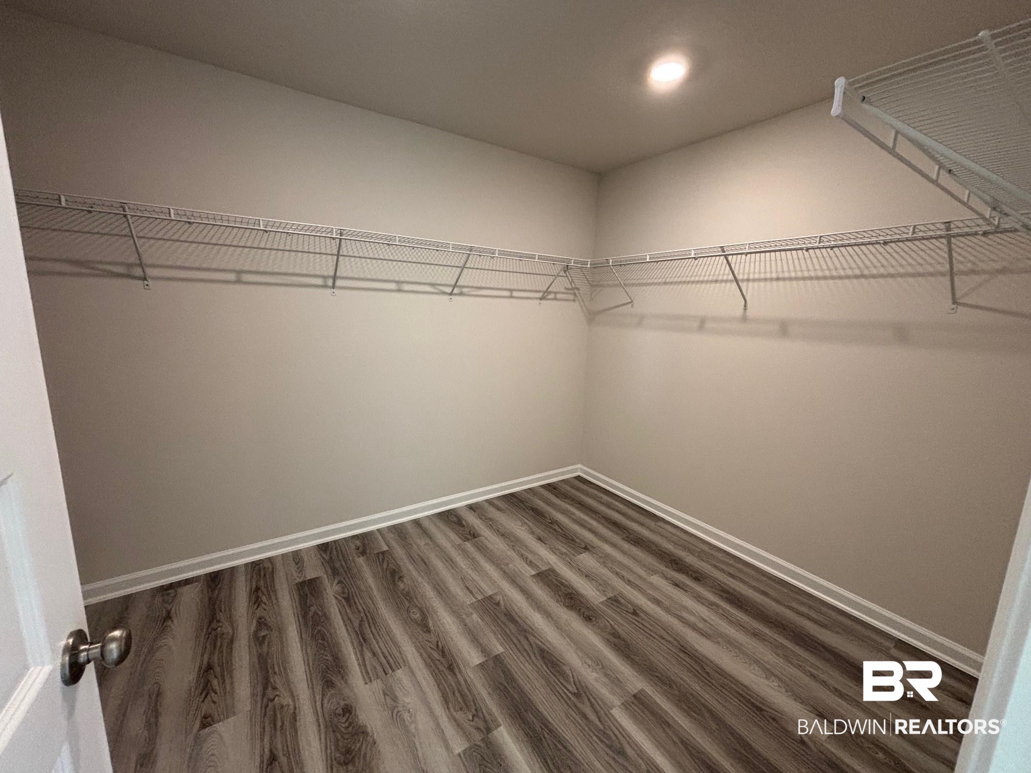 22044 Aleutian Avenue Foley, AL 36535 - Photo 17 of 28 Spacious closet with dark hardwood / wood-style flooring