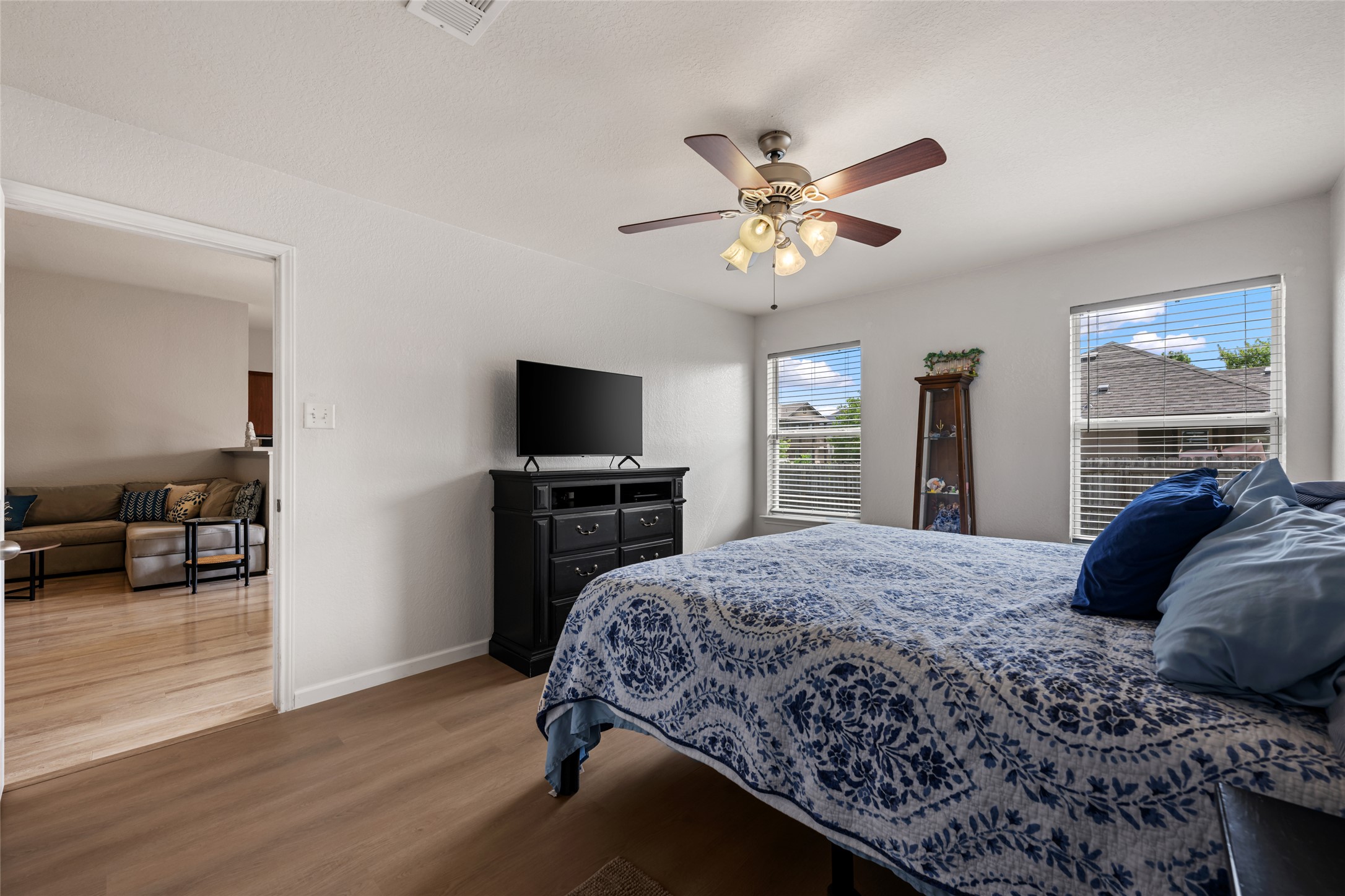 144 Calcite Lane Jarrell, TX 76537 - Photo 20 of 38 Natural light illuminates this cozy bedroom, creating a peaceful retreat with warm wood flooring.