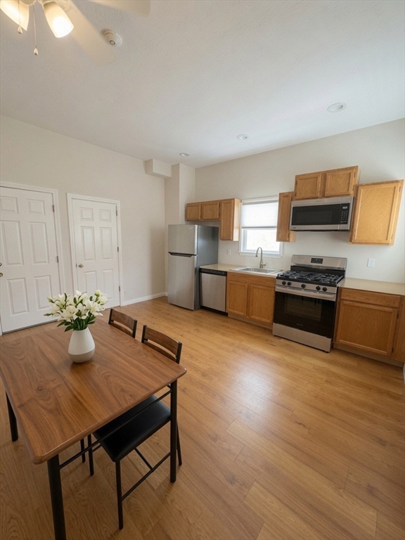 37 Madison Street, Unit 37 Malden, MA 02148 - Photo 1 of 10 a kitchen with sink cabinets and wooden floor