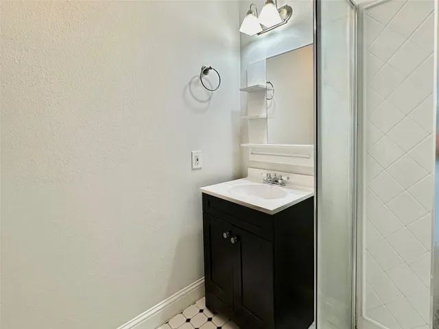 a bathroom with a sink and mirror