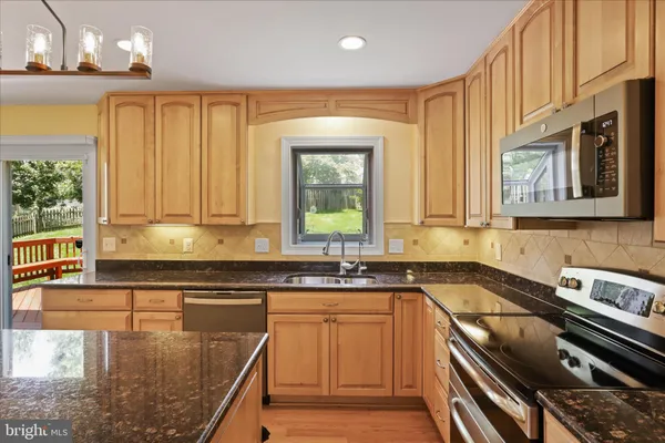 a bathroom with a granite countertop sink toilet and a shower