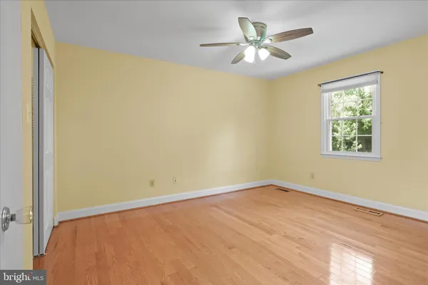 a bathroom with a granite countertop bathtub shower sink vanity and toilet