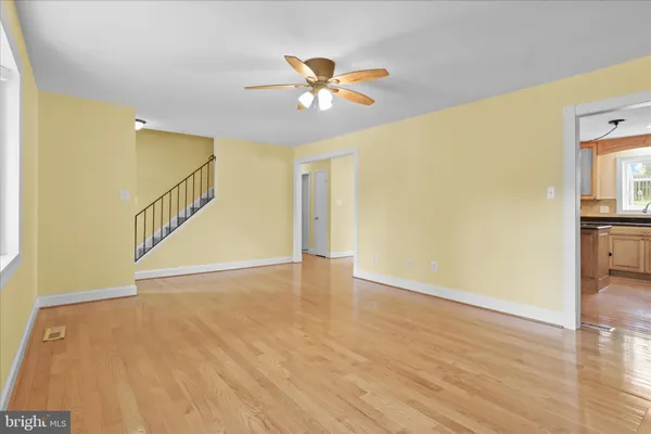 a kitchen with granite countertop a stove a sink and a refrigerator
