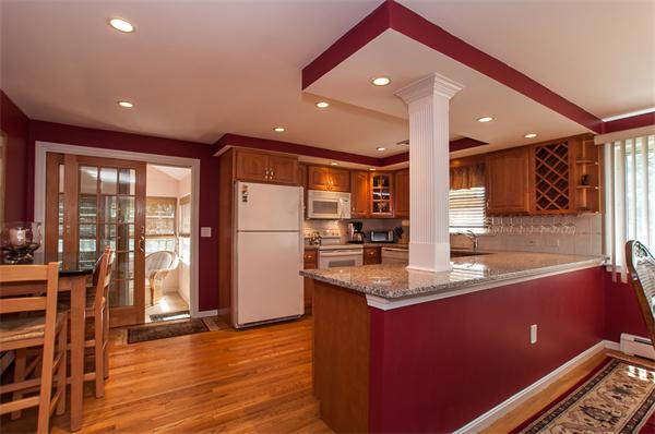 19 Carroll Road Woburn, MA 01801 - Photo 4 of 12 a kitchen with stainless steel appliances granite countertop a sink and a refrigerator