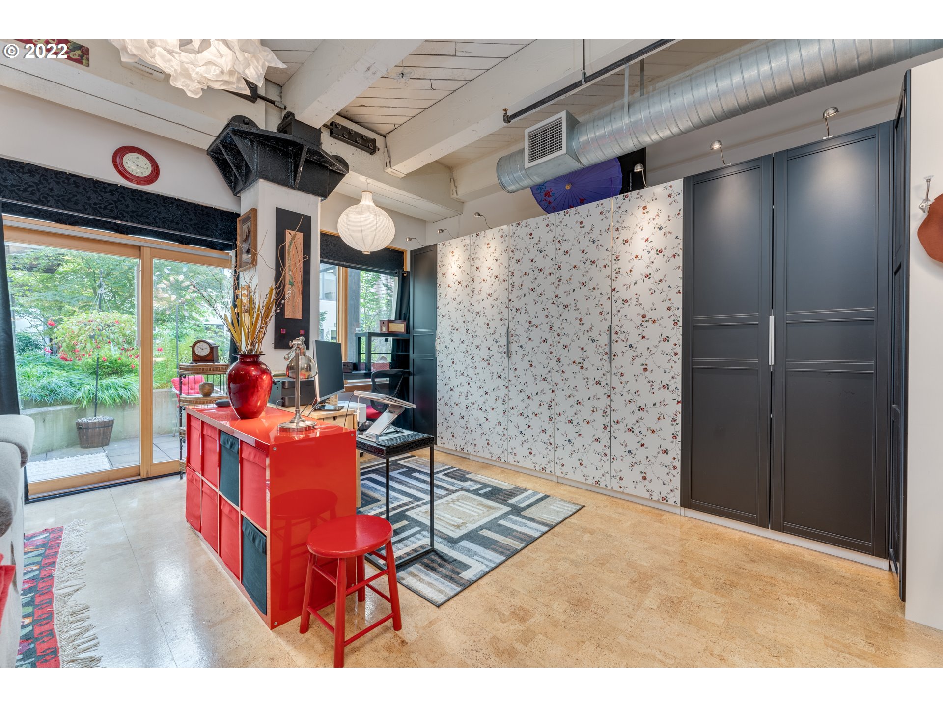 1420 Northwest Lovejoy Street, Unit 327 Portland, OR 97209 - Photo 12 of 27 a living room with furniture a flat screen tv and a floor to ceiling window