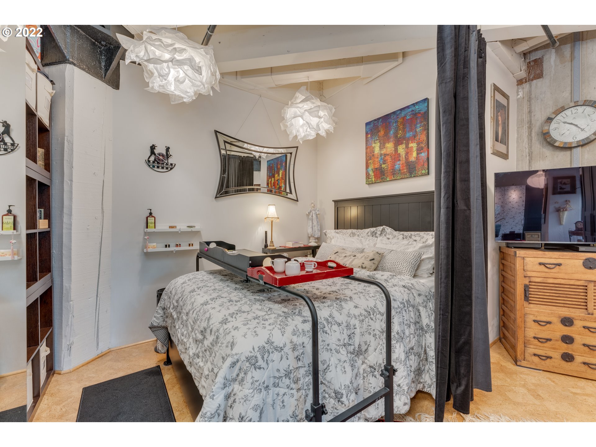 1420 Northwest Lovejoy Street, Unit 327 Portland, OR 97209 - Photo 17 of 27 a bedroom with a bed a dresser and book shelf