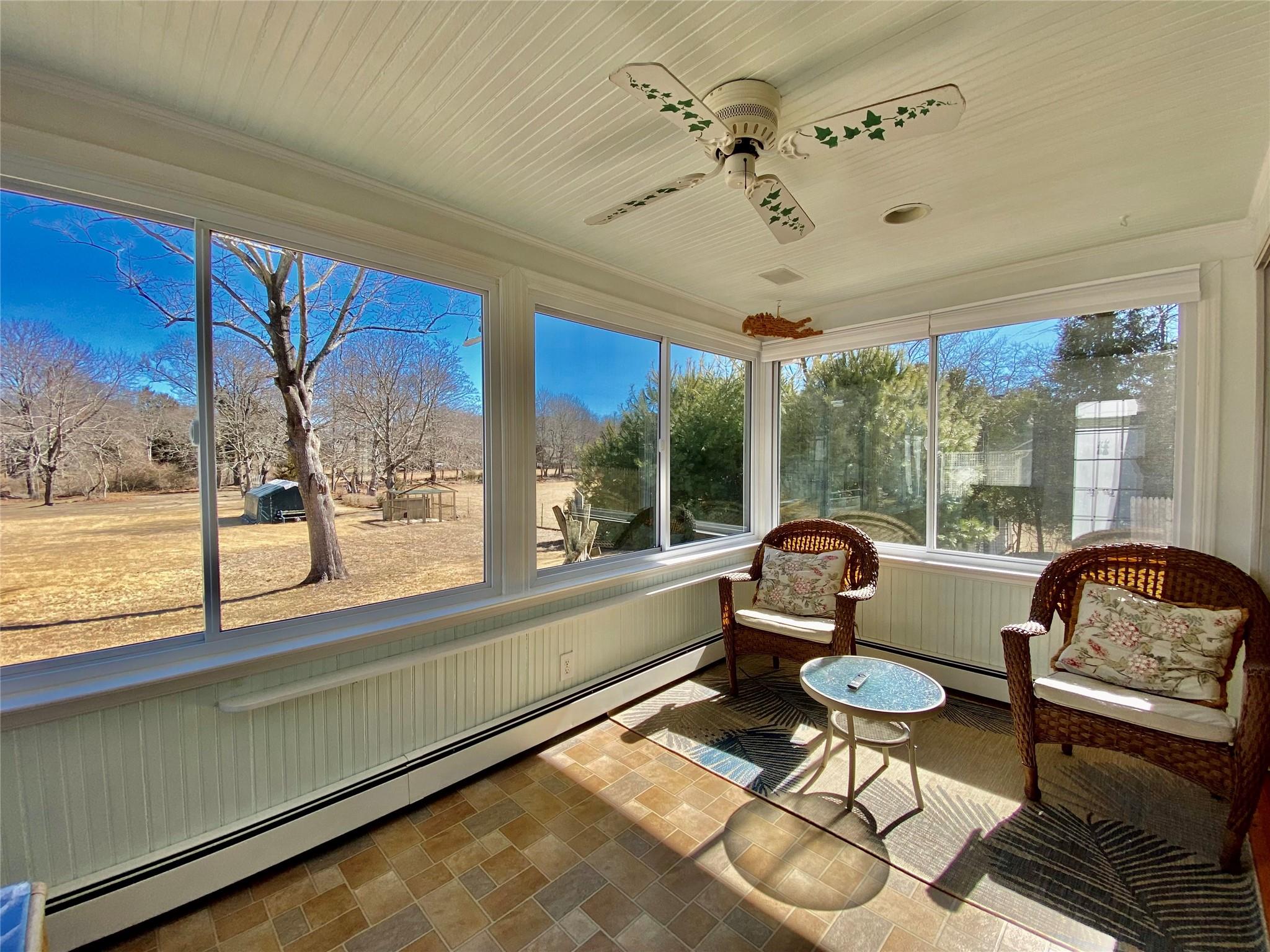 3825 South Harbor Road Southold, NY 11971 - Photo 8 of 15 Sunroom featuring ceiling fan and baseboard heating