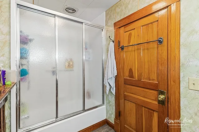 a bathroom with a glass shower door