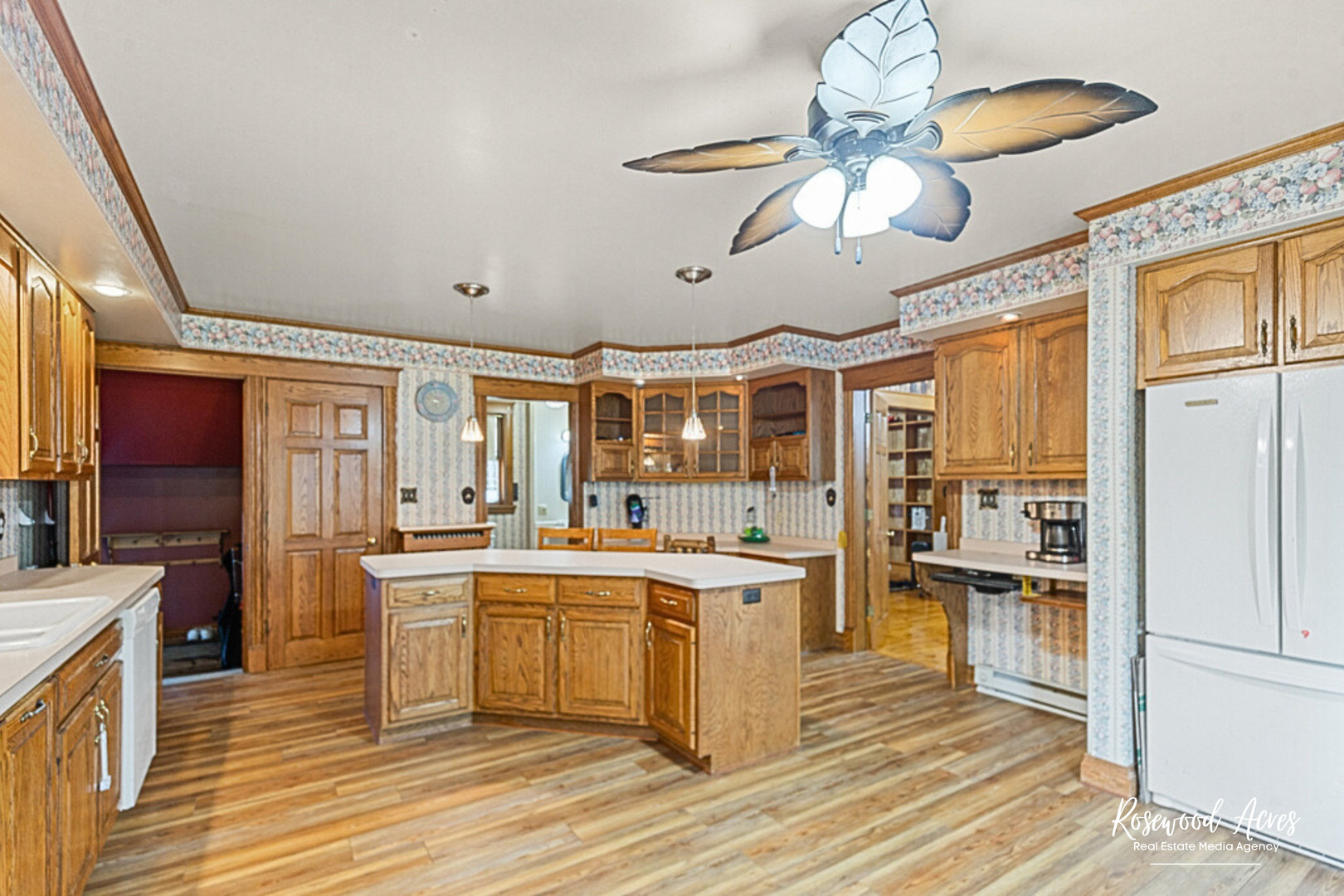 502 South Main Street Long Point, IL 61333 - Photo 4 of 22 a large kitchen with a chandelier and stainless steel appliances