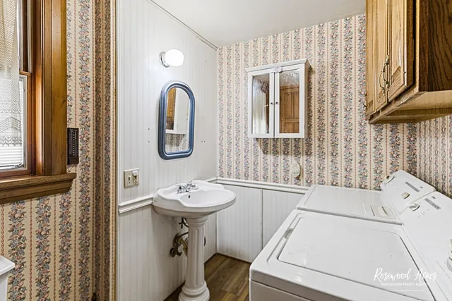 a bathroom with a sink a mirror and a window