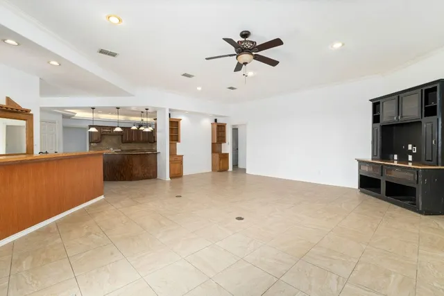 a view of a kitchen with a sink and refrigerator