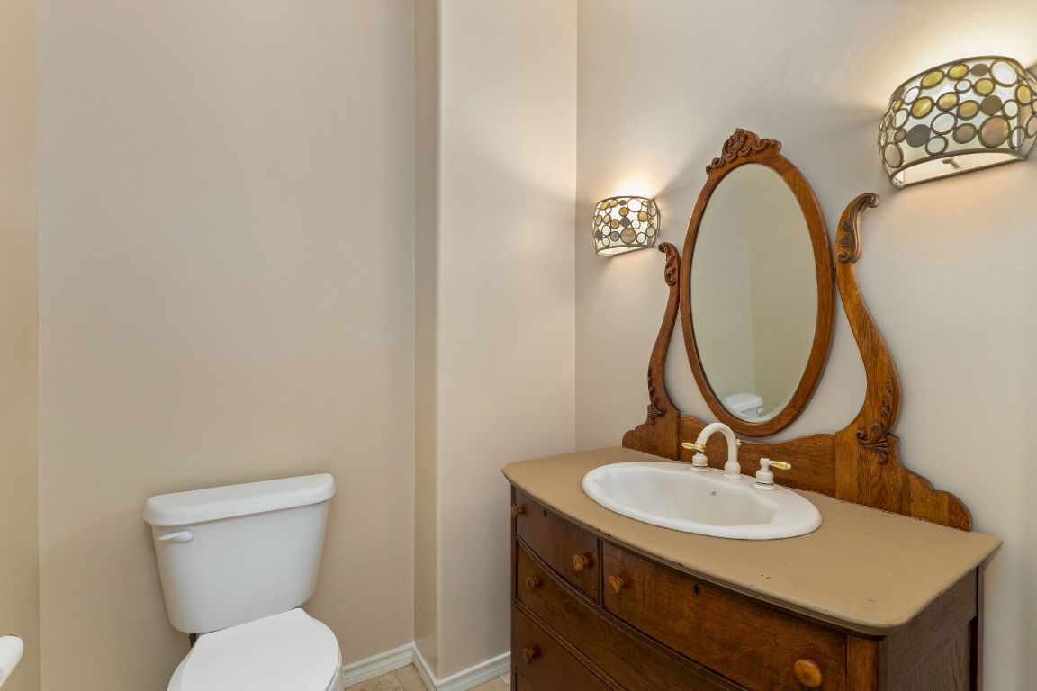 803 South Converse Street Flatonia, TX 78941 - Photo 16 of 35 a bathroom with a toilet a sink and a mirror
