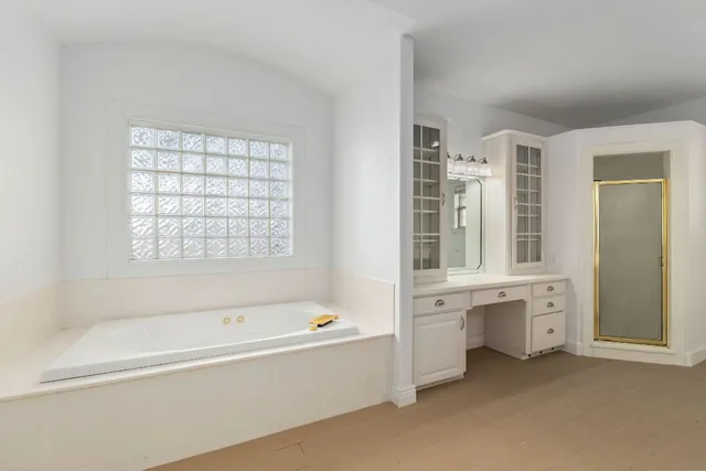 a bathroom with sink bathtub and window