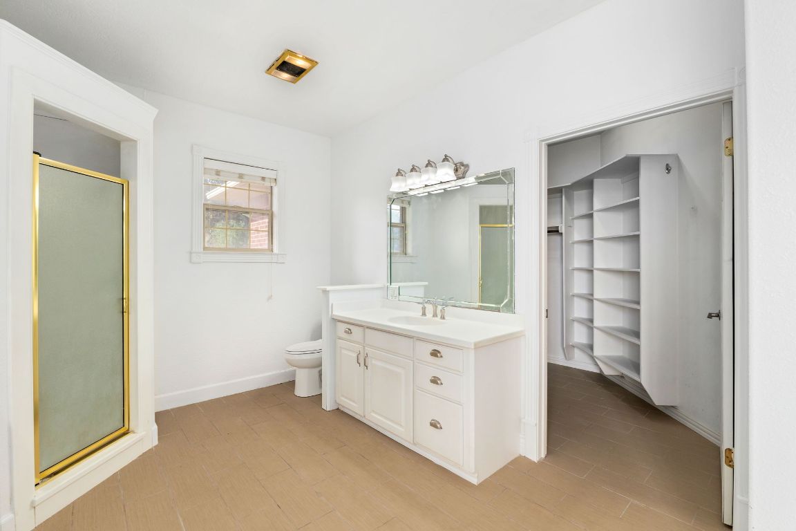 803 South Converse Street Flatonia, TX 78941 - Photo 21 of 35 a bathroom with a double vanity sink a toilet and shower