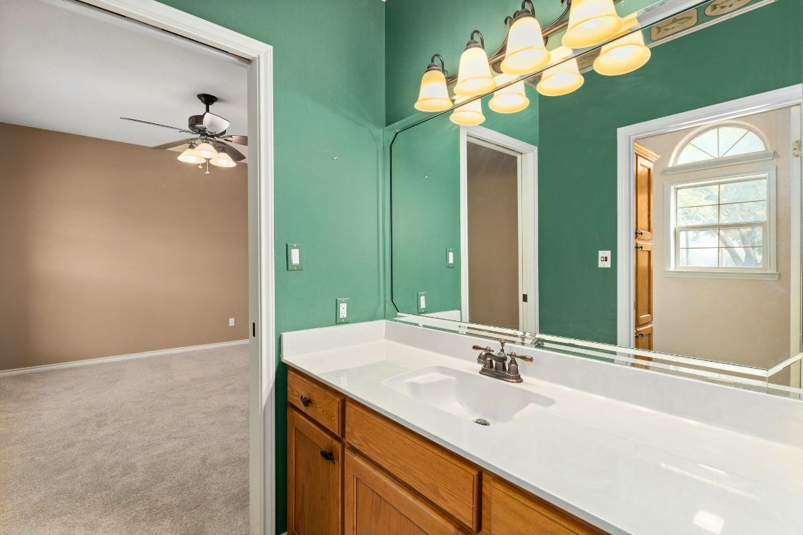 803 South Converse Street Flatonia, TX 78941 - Photo 26 of 35 a bathroom with a sink a mirror and a light fixture