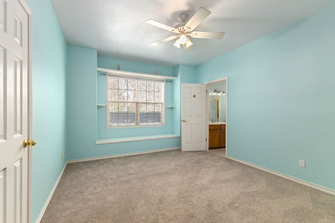 803 South Converse Street Flatonia, TX 78941 - Photo 29 of 35 an empty room with chandelier fan and windows