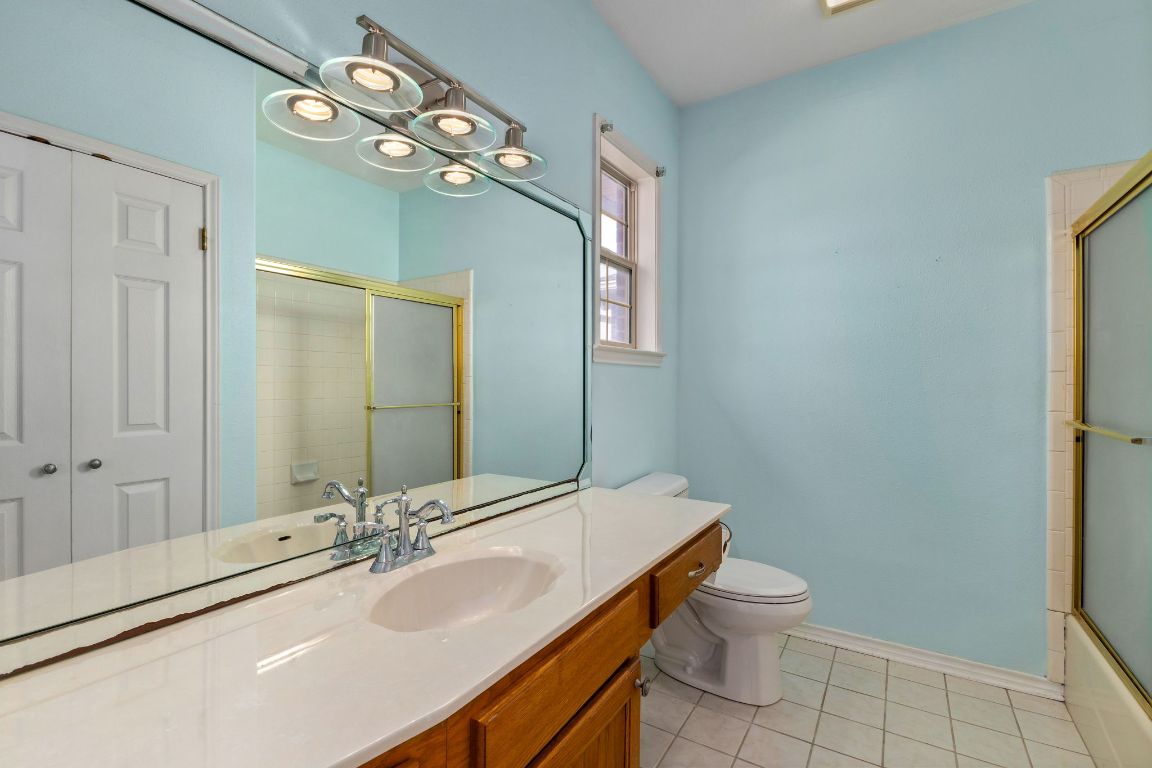 803 South Converse Street Flatonia, TX 78941 - Photo 30 of 35 a bathroom with a double vanity sink toilet and a mirror