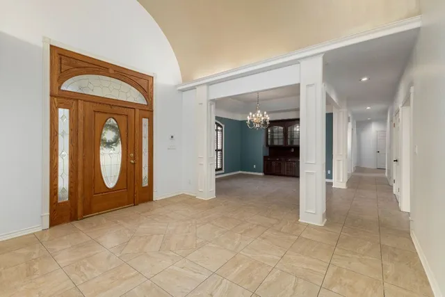 a view of a room with large mirror and cabinets