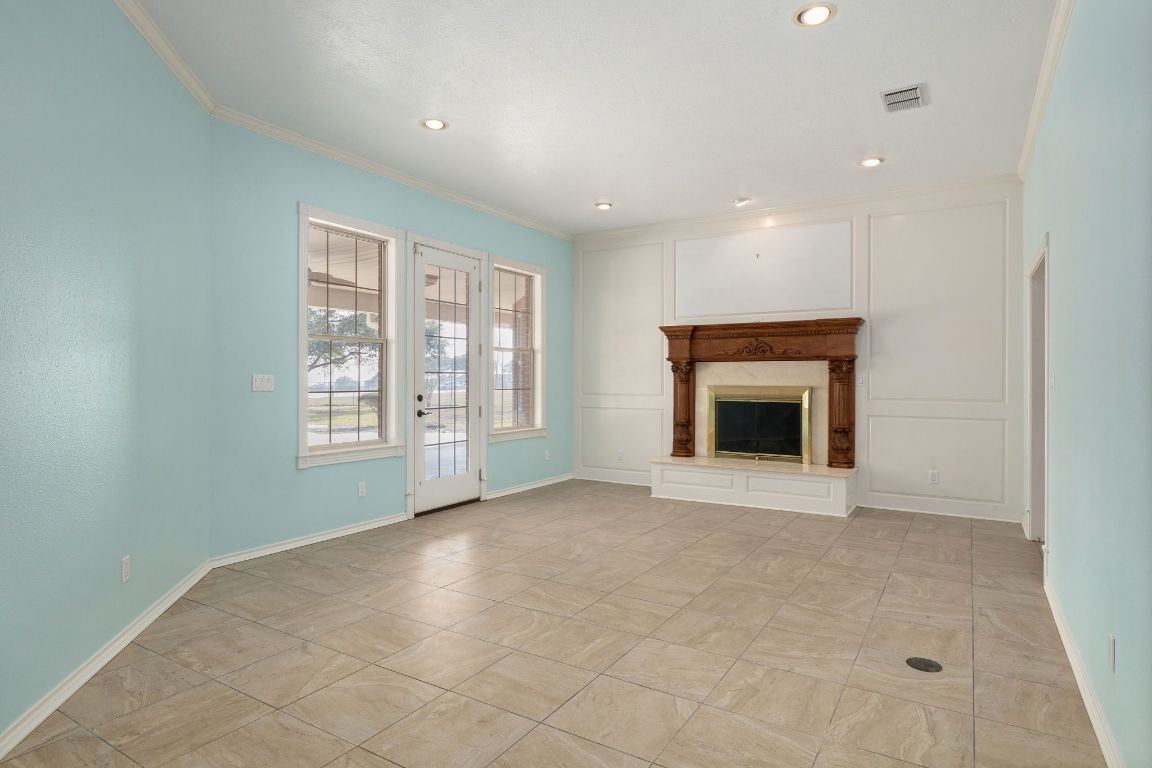 803 South Converse Street Flatonia, TX 78941 - Photo 7 of 35 a view of an empty room with a window and fireplace