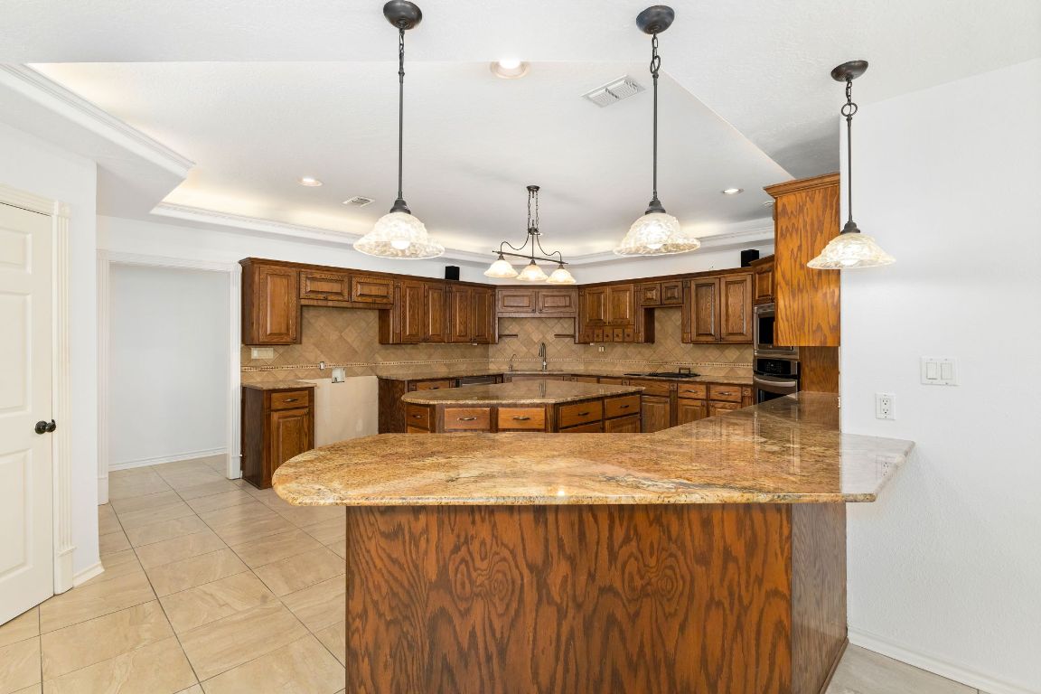 803 South Converse Street Flatonia, TX 78941 - Photo 9 of 35 a kitchen with stainless steel appliances granite countertop sink a stove and oven