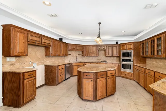 a kitchen with a stove sink and cabinets