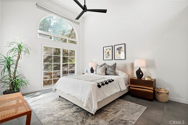 a bedroom with a bed and a potted plant