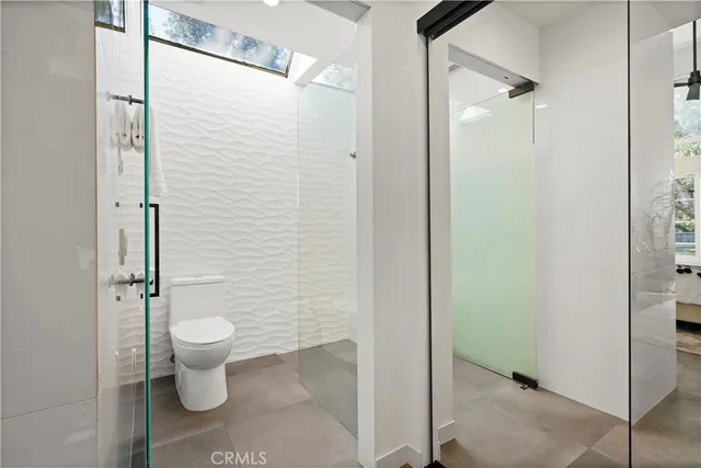 a bathroom with a toilet and a shower