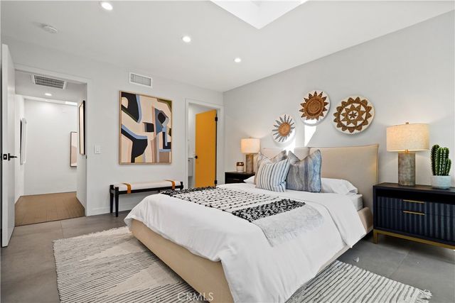 a bedroom with a bed and dresser