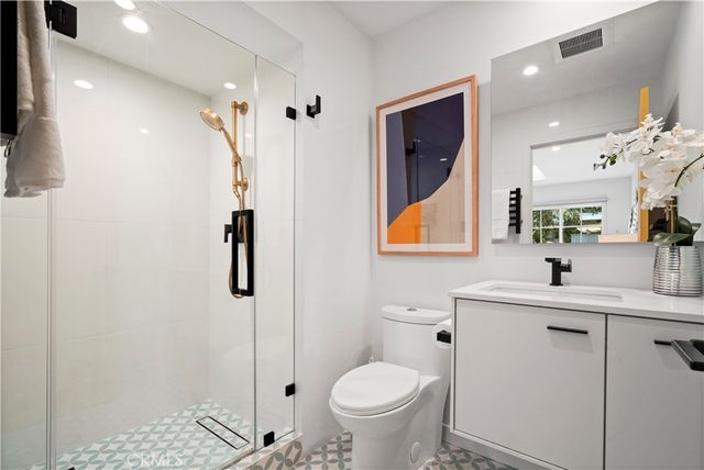 a bathroom with a toilet sink and shower
