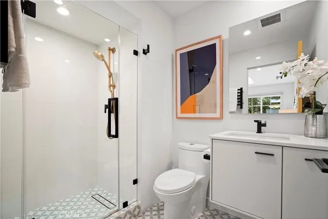 a bathroom with a toilet sink and shower