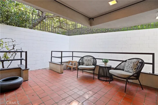 a view of a house with backyard sitting area and garden