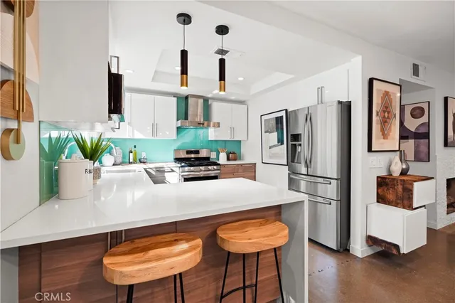 a kitchen with stainless steel appliances a refrigerator and a stove