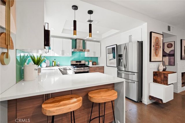 a kitchen with stainless steel appliances a refrigerator and a stove