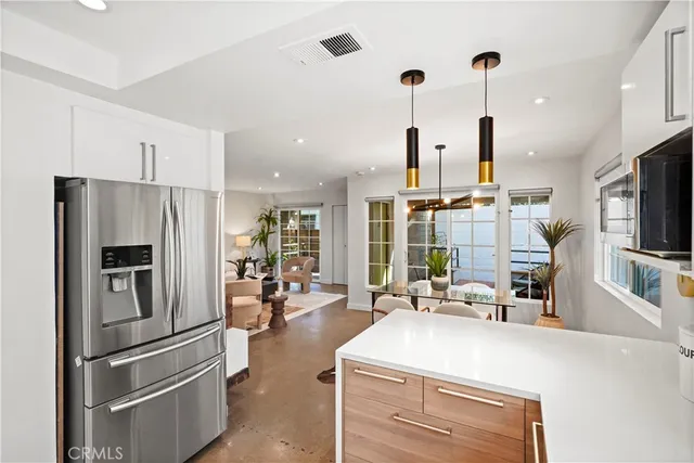 a kitchen with stainless steel appliances a refrigerator a stove and a sink