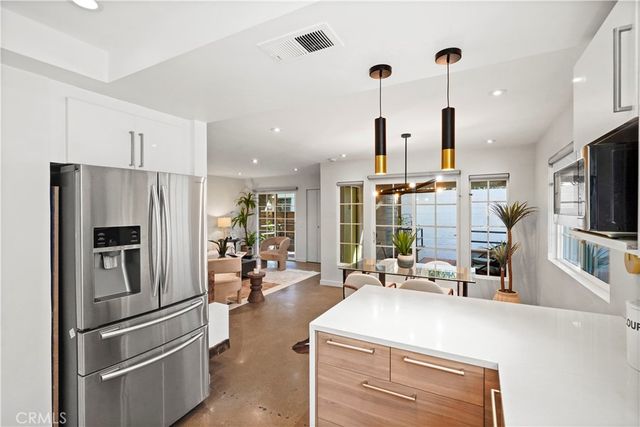 a kitchen with stainless steel appliances a refrigerator a stove and a sink