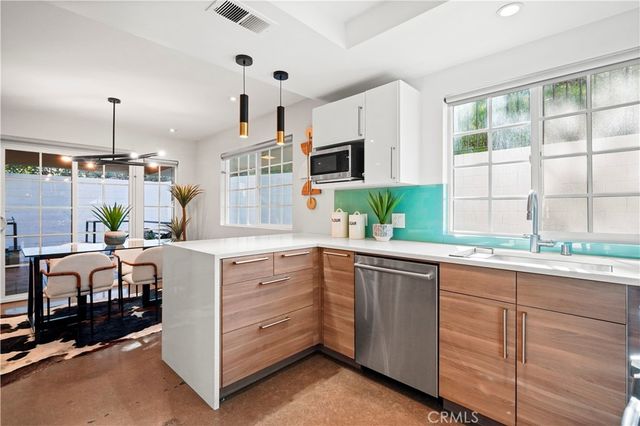 a kitchen with cabinets and window