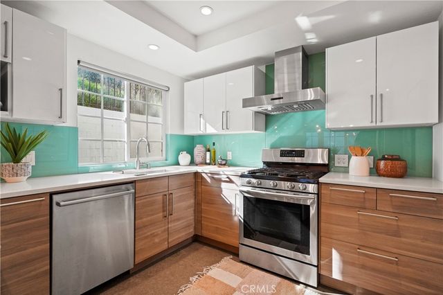 a kitchen with cabinets a sink and appliances