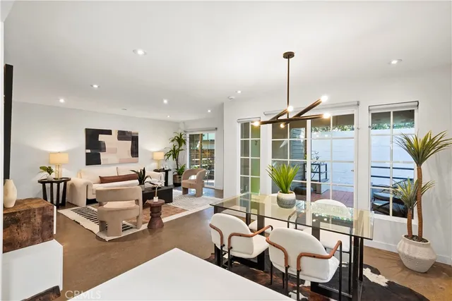 a living room with furniture a table and chairs